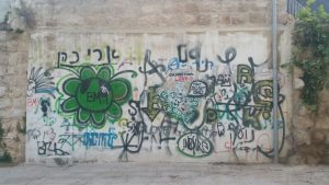 לפני - הקיר מלא בכתובות גרפיטי (צילום אלכס חייצקי)